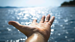 承诺者用一张在开阔水面上伸出的手的照片表示